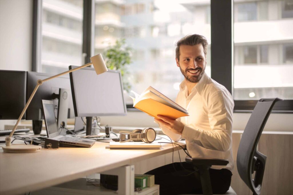 Blog photo of man holding a book 927022 scaled 1 1024x683